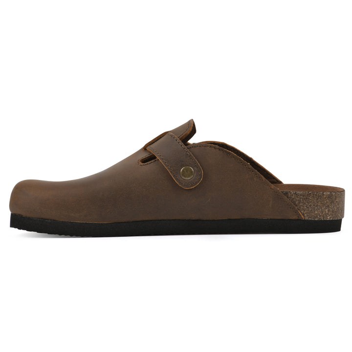 Side view of a whiskey leather clog with metal buckle on an adjustable strap, and a brown sole with black bottom