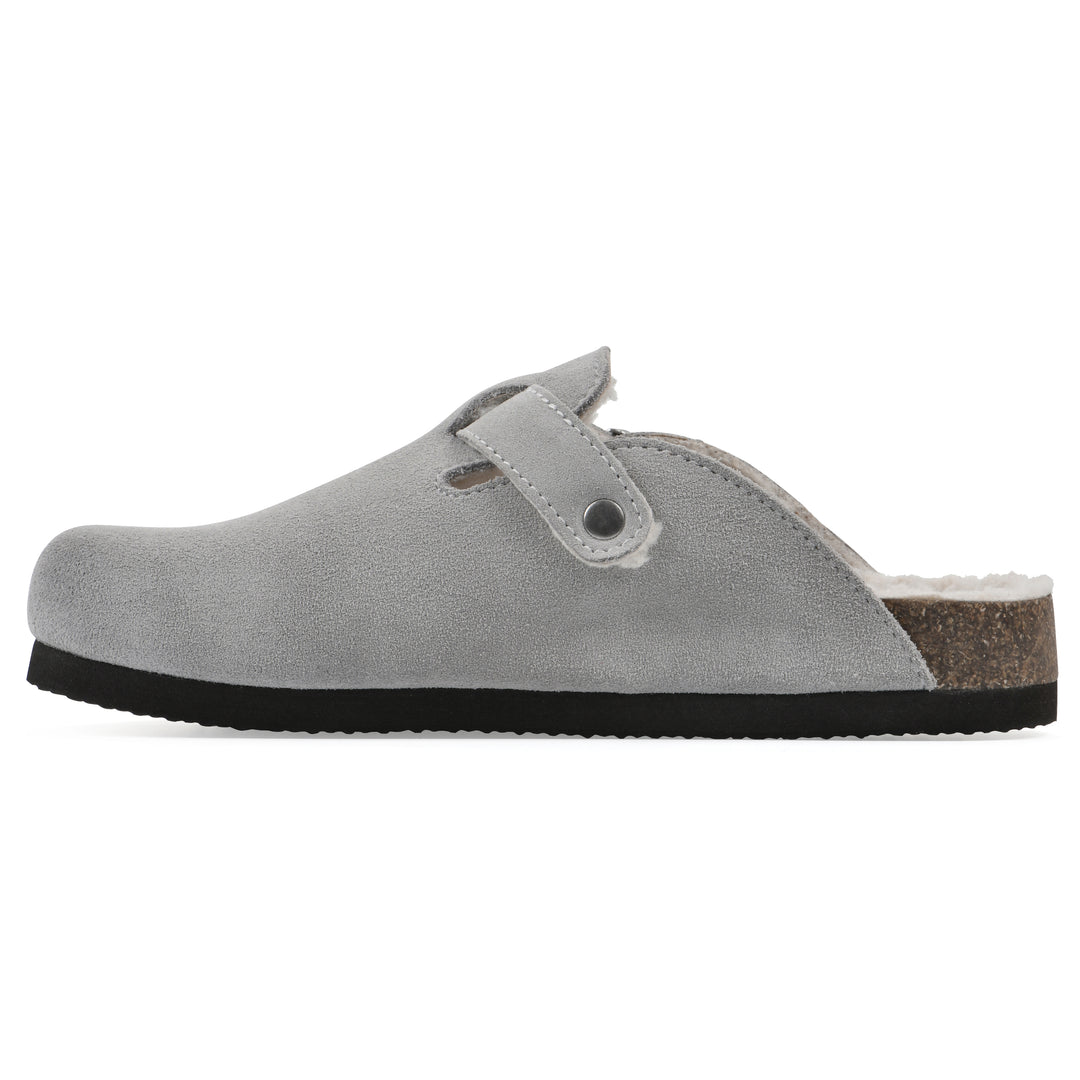 Side view of a light grey suede clog with white faux shearling lining, a metal buckle on an adjustable strap, and a brown sole with black bottom