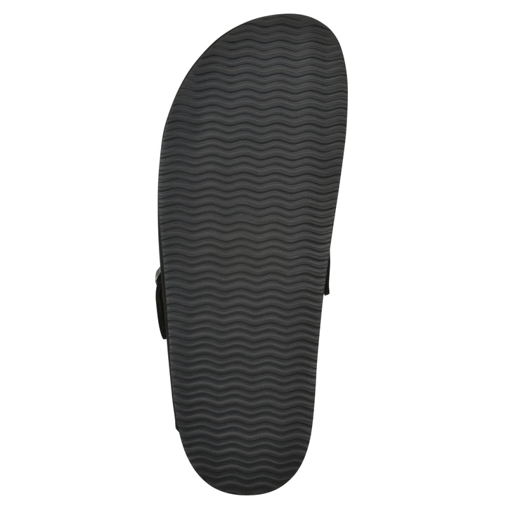 Sole view of a black leather clog with metal buckle on an adjustable strap, and a brown sole with black patterned bottom