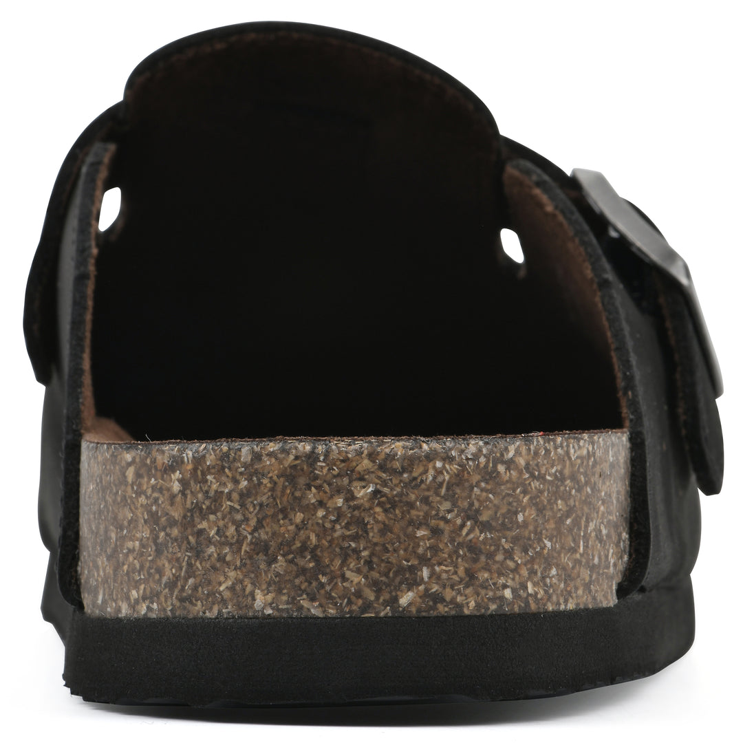Rear view of a black leather clog with metal buckle on an adjustable strap, and a brown sole with black bottom