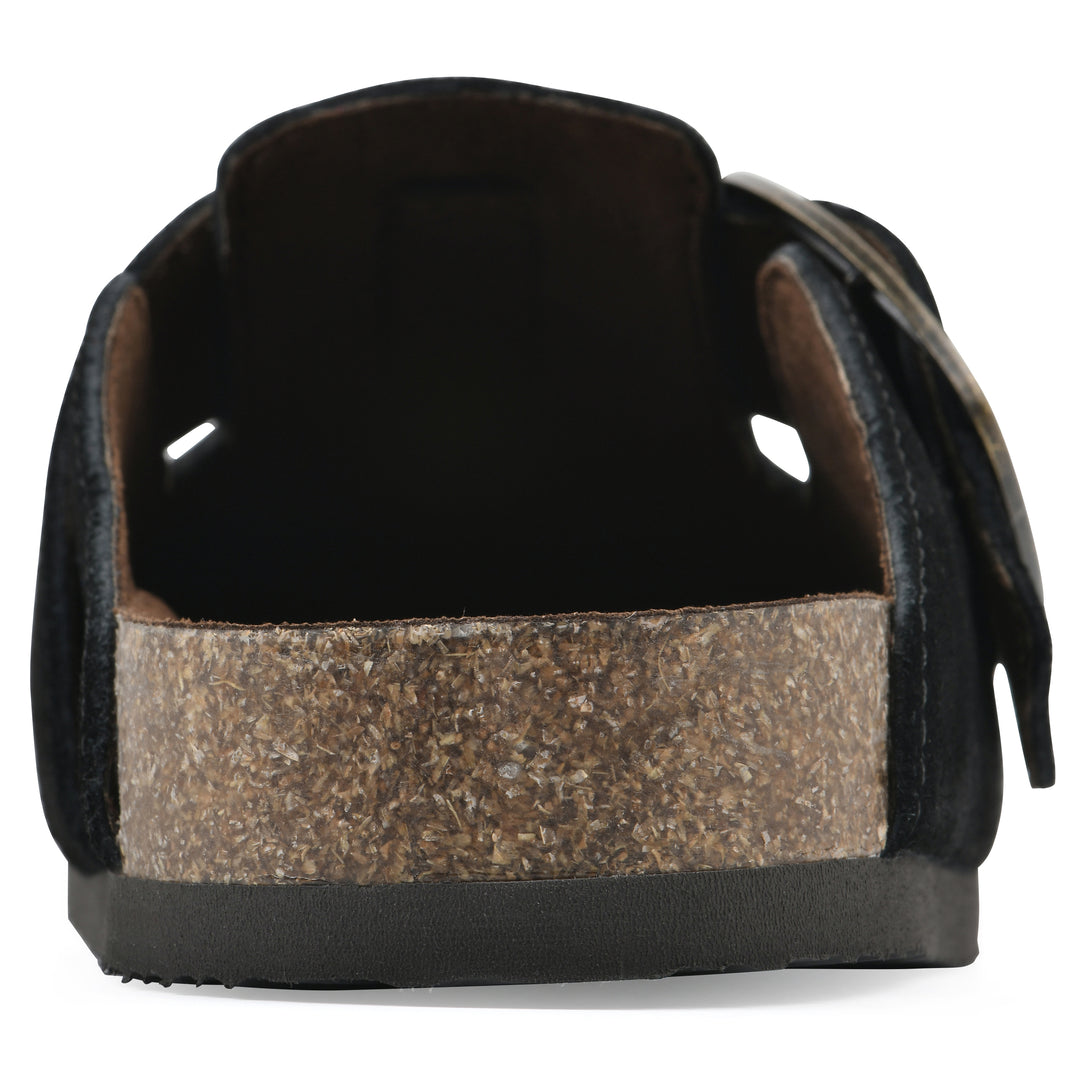 Rear view of a black suede backless clog with large adjustable buckle and a black sole
