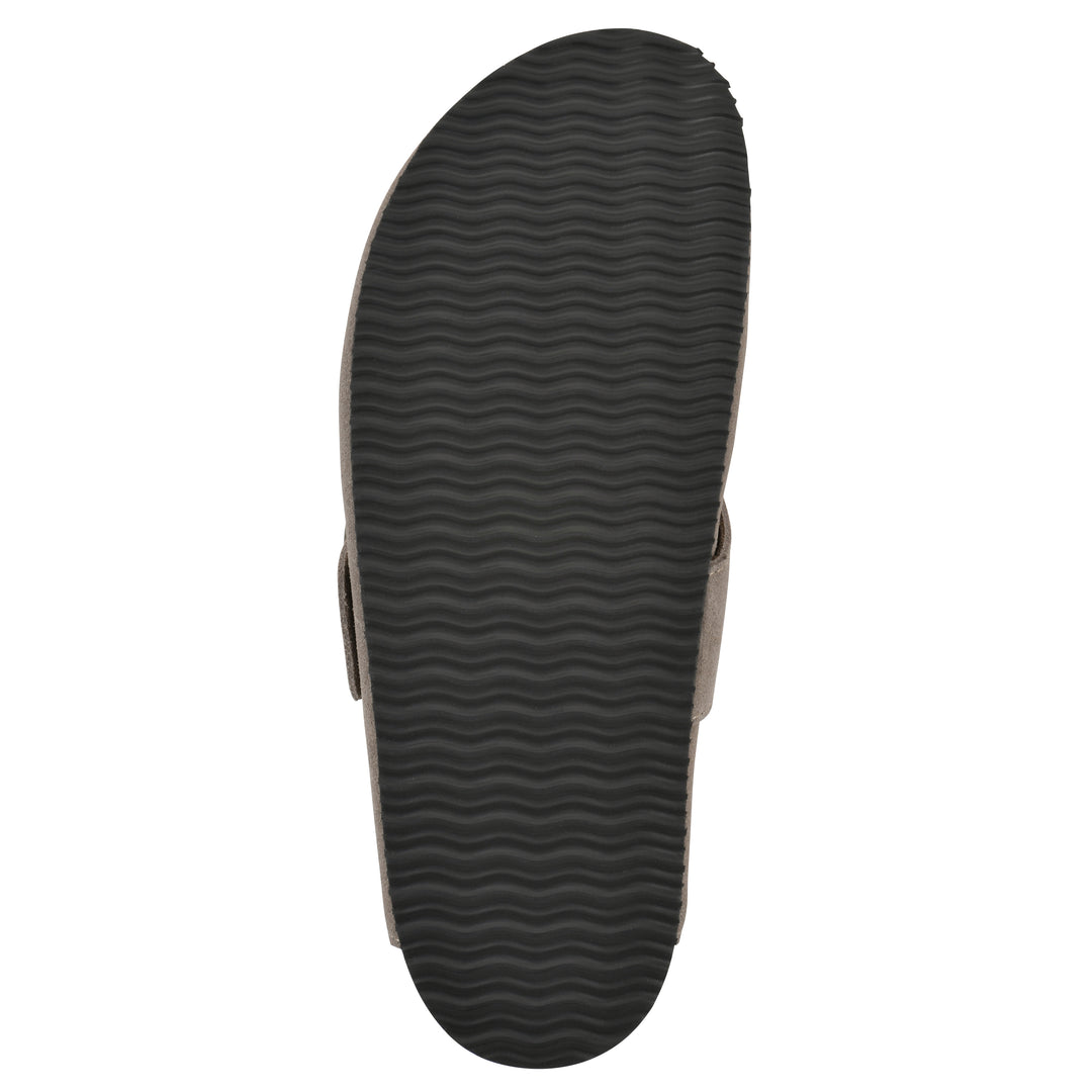 Rear view of a taupe suede backless clog with large adjustable buckle and a black sole