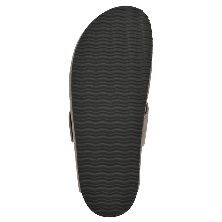 Rear view of a taupe suede backless clog with large adjustable buckle and a black sole