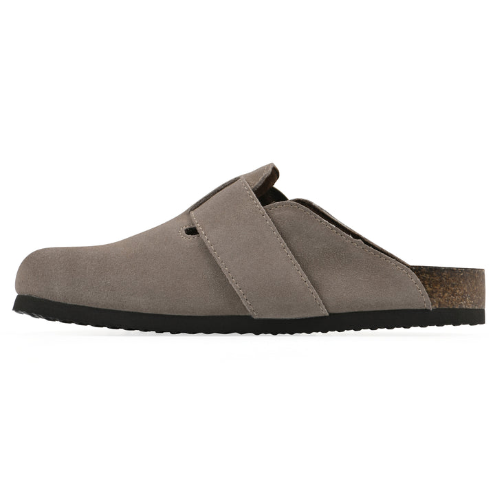 Side view of a taupe suede backless clog with large adjustable buckle and a black sole
