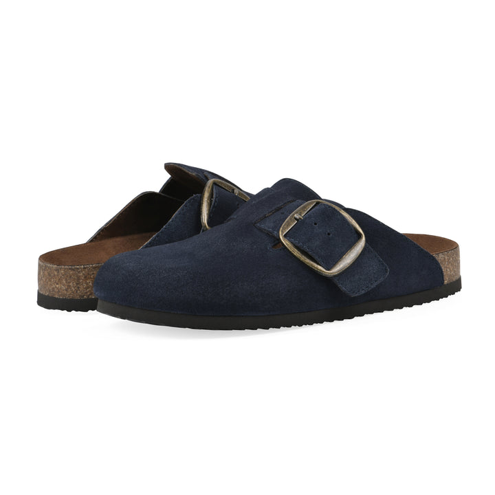 Angle view of a pair of navy suede backless clogs with large adjustable buckle and a black sole