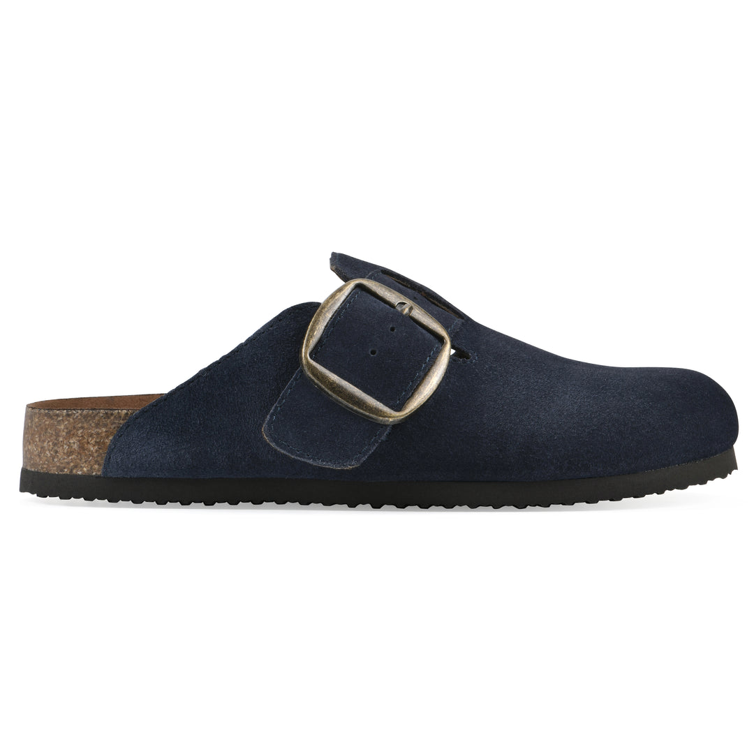 Side view of a navy suede backless clog with large adjustable buckle and a black sole