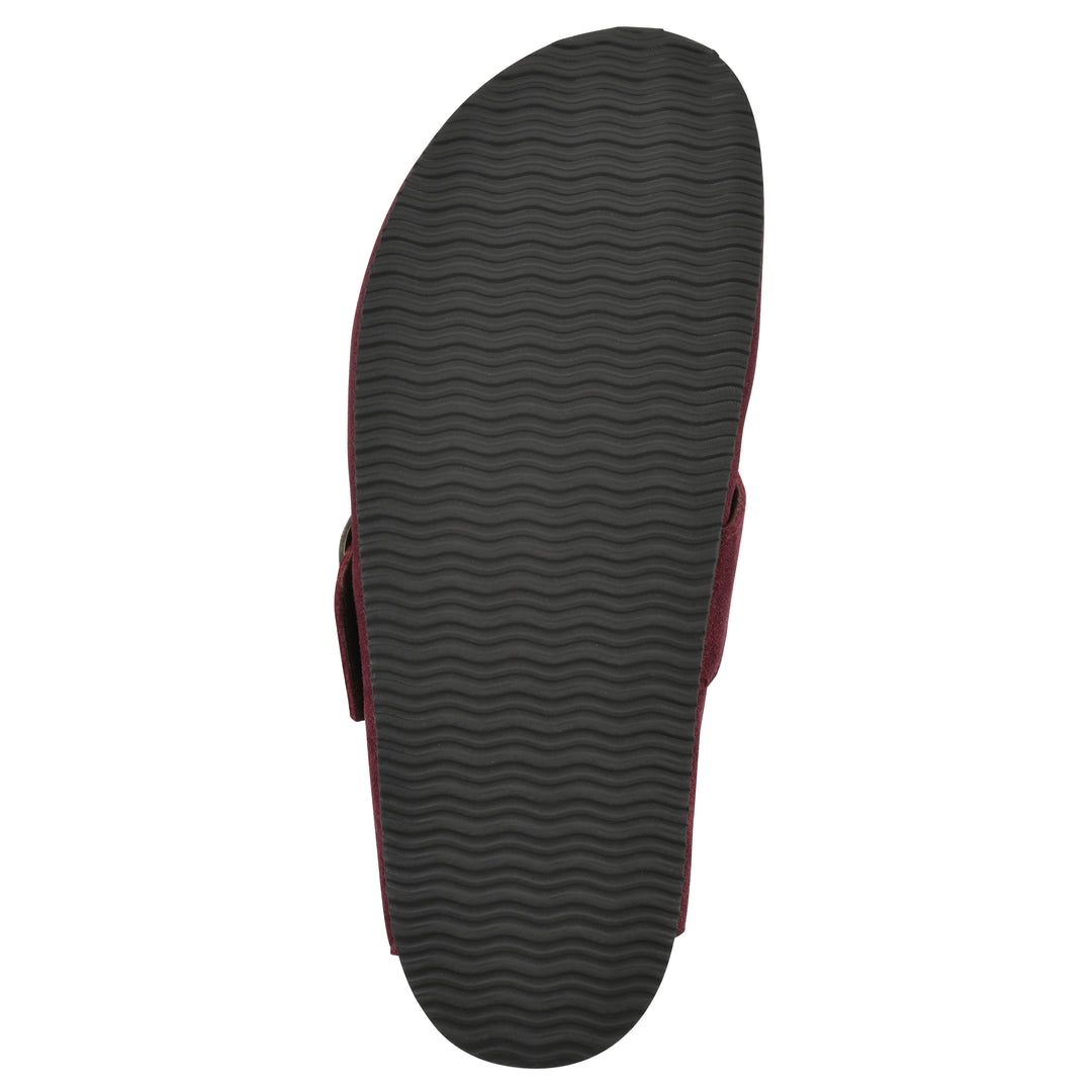 Sole view of a burgundy suede backless clog with large adjustable buckle and a black sole