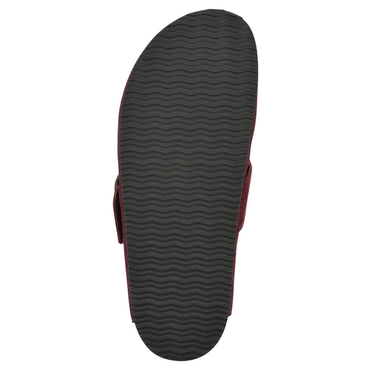 Sole view of a burgundy suede backless clog with large adjustable buckle and a black sole