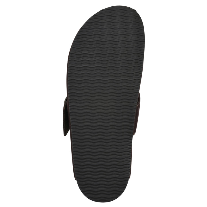 Sole view of a brown suede backless clog with large adjustable buckle and a black sole