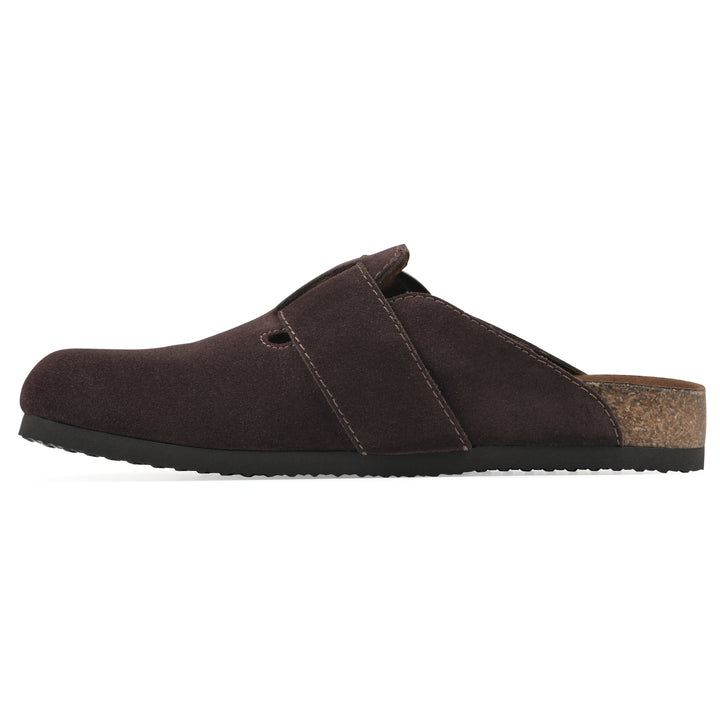 Side view of a brown suede backless clog with large adjustable buckle and a black sole