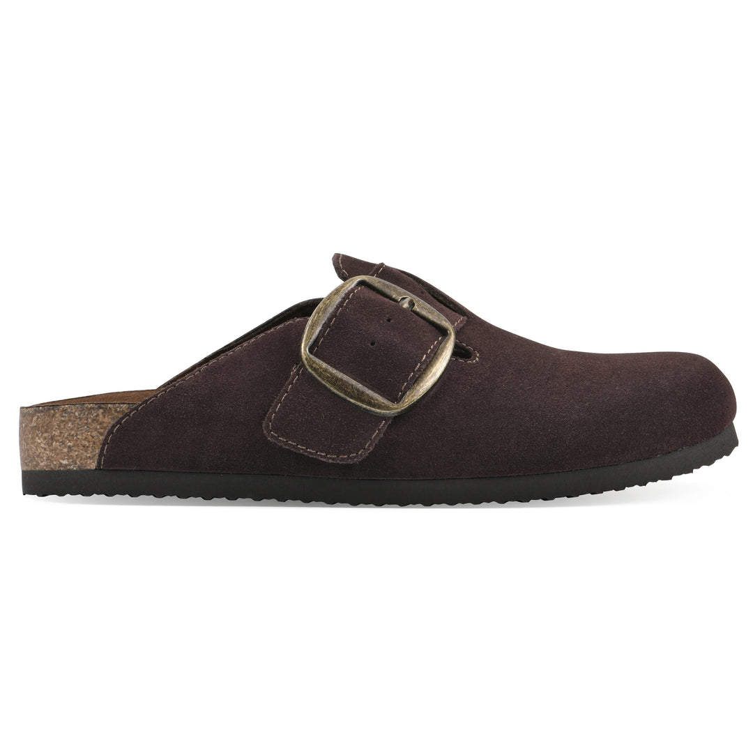 Side view of a brown suede backless clog with large adjustable buckle and a black sole