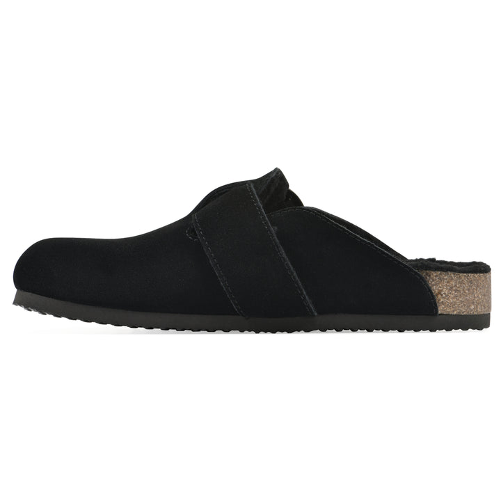 Side view of a black suede backless clog with large adjustable buckle and a black sole