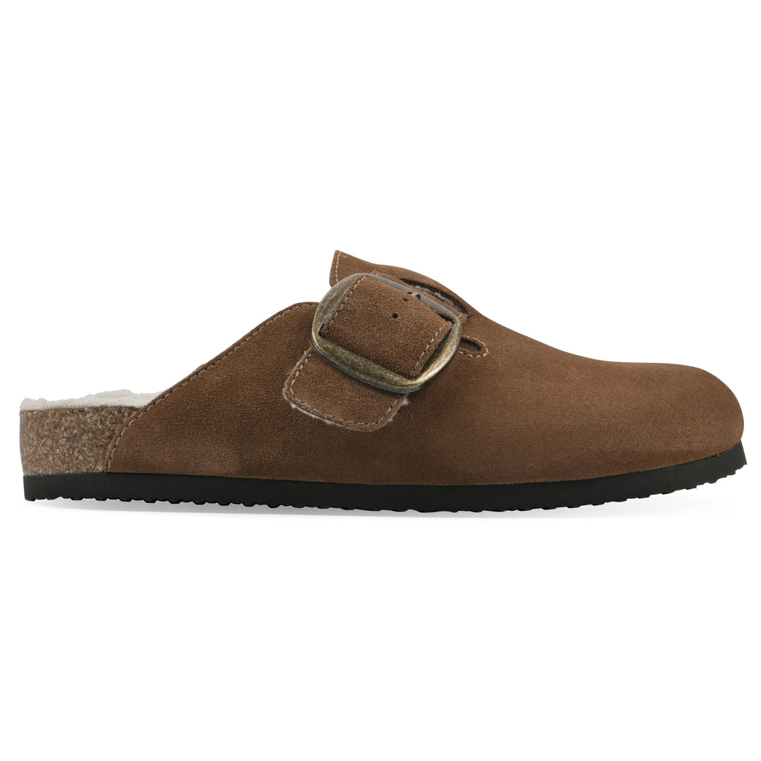 Side view of a chestnut suede backless clog with cream, faux fur lining, a large adjustable buckle, and a black sole