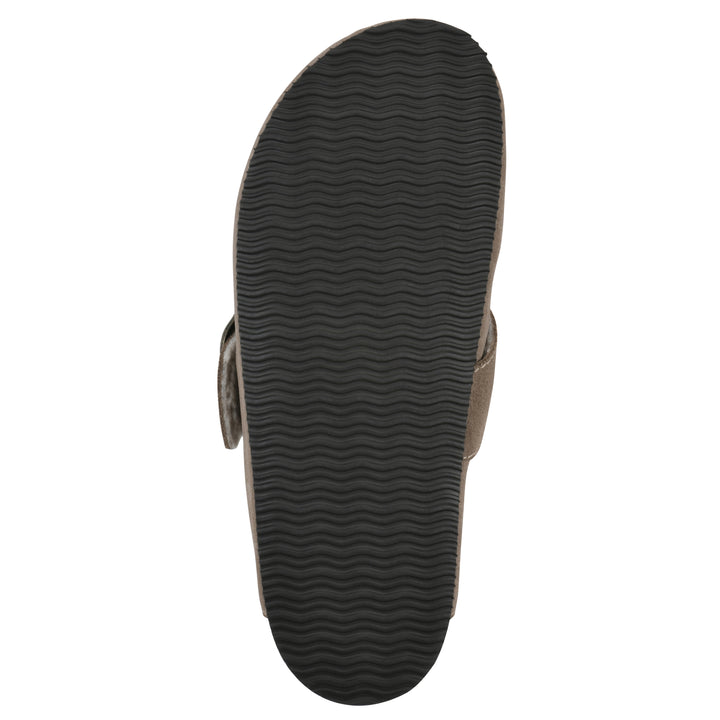 Sole view of a taupe suede backless clog with cream, faux fur lining, a large adjustable buckle, and a black sole