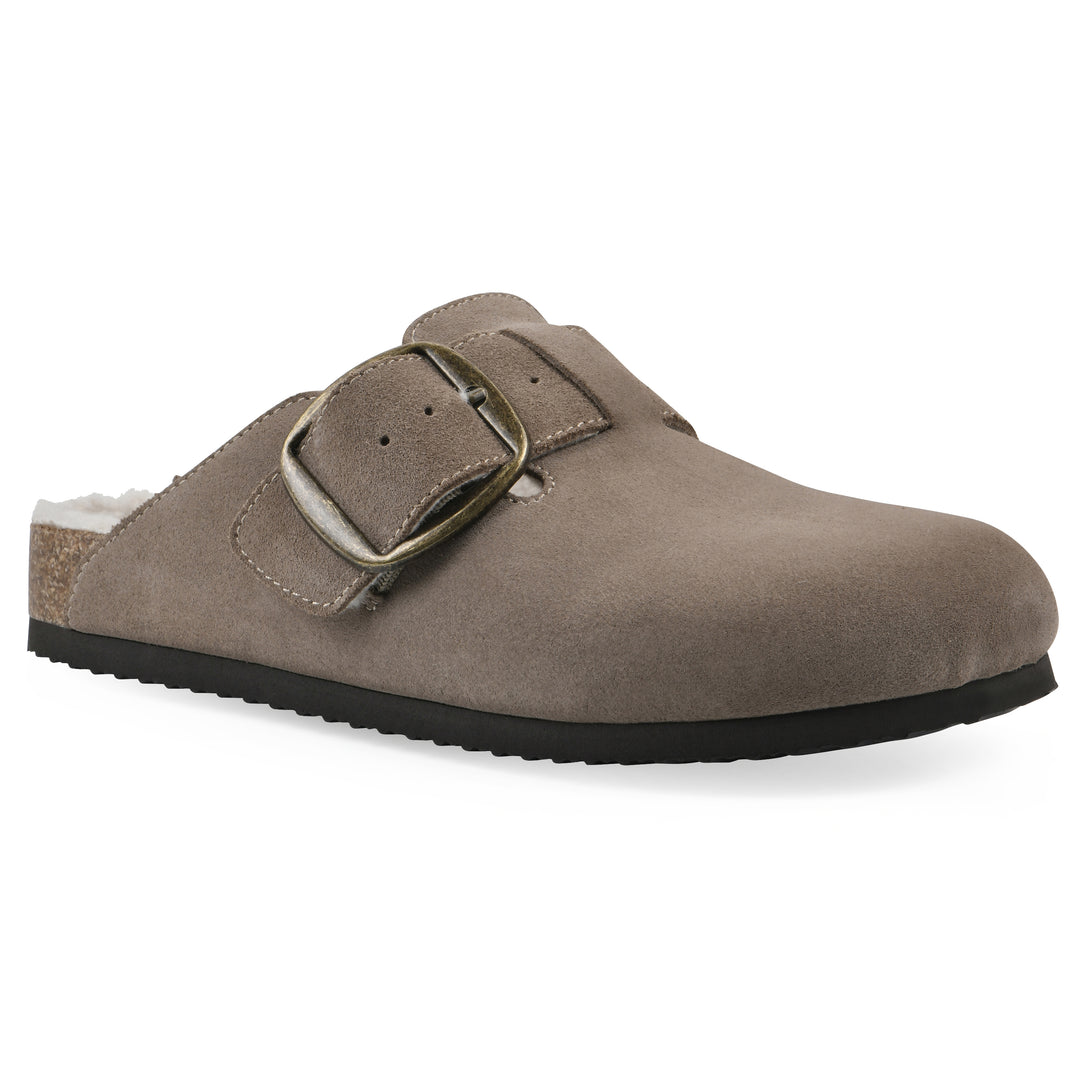 Angle view of a taupe suede backless clog with cream, faux fur lining, a large adjustable buckle, and a black sole