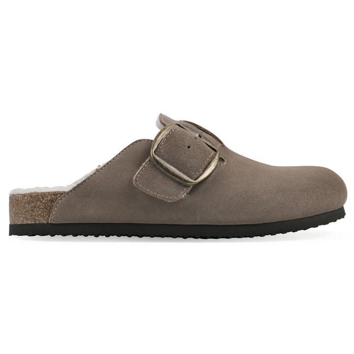 Side view of a taupe suede backless clog with cream, faux fur lining, a large adjustable buckle, and a black sole