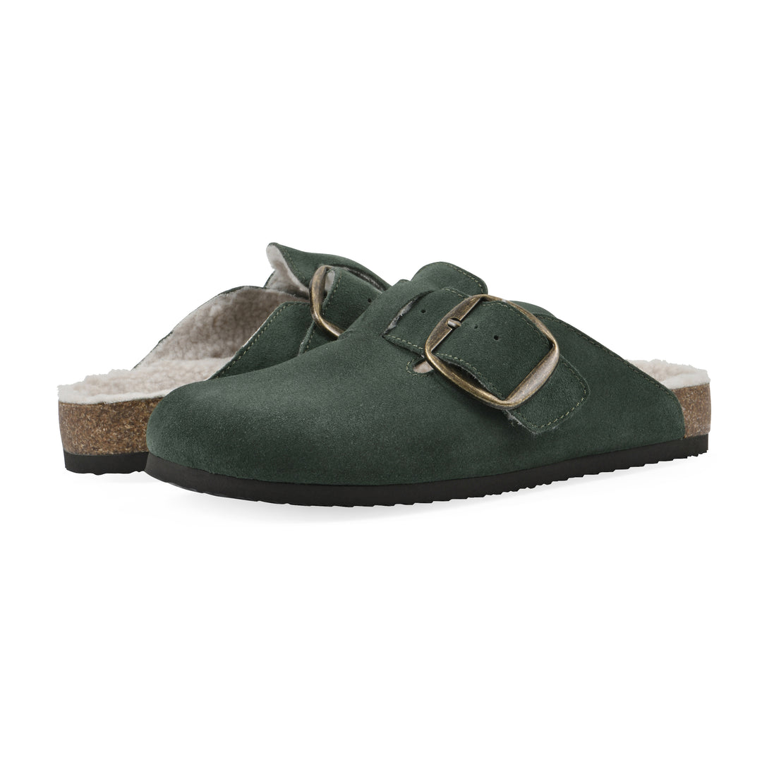 Angle view of a pair of hunter green suede backless clogs with cream, faux fur lining, a large adjustable buckle, and a black sole