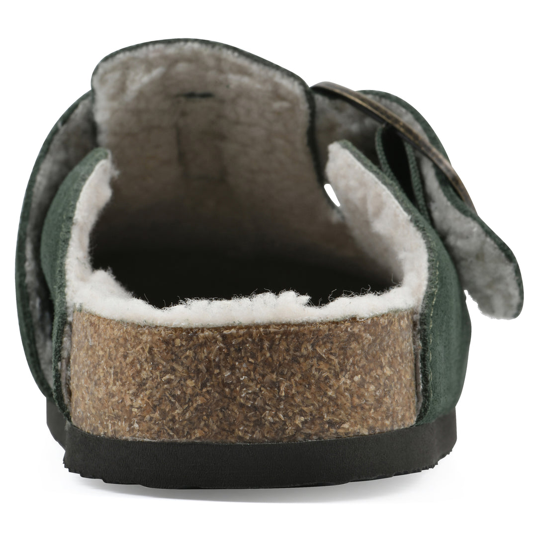 Rear view of a hunter green suede backless clog with cream, faux fur lining, a large adjustable buckle, and a black sole