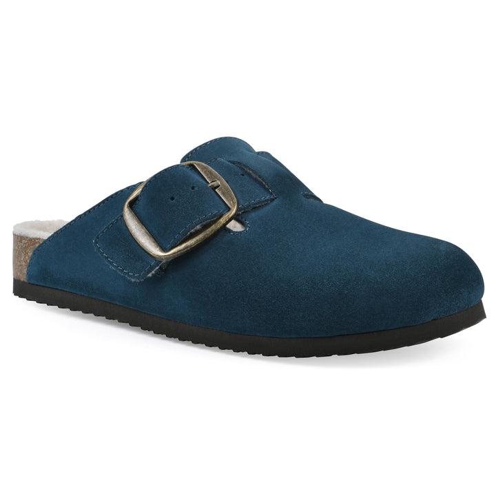 Angle view of a blue suede backless clog with cream, faux fur lining, a large adjustable buckle, and a black sole