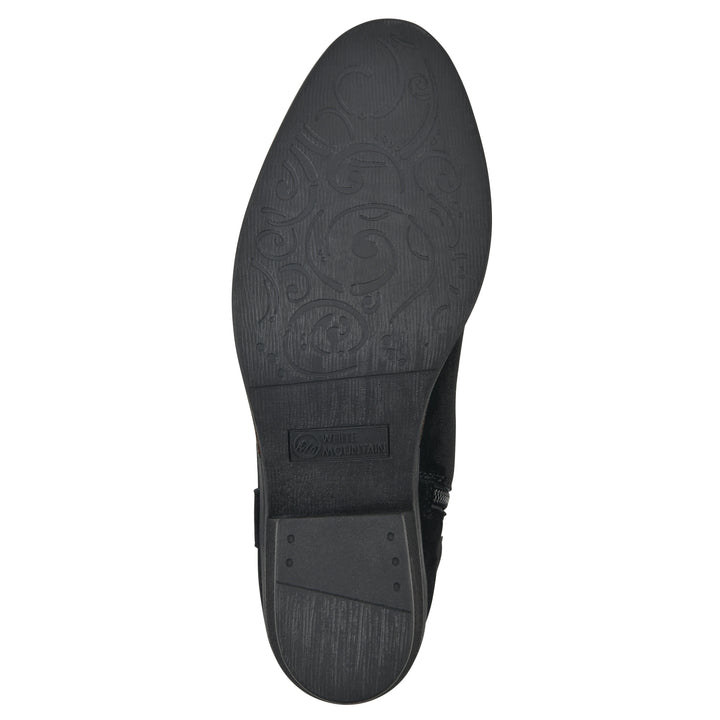 Sole view of a black suede tall boot with a low stacked, black heel, and tapered toe