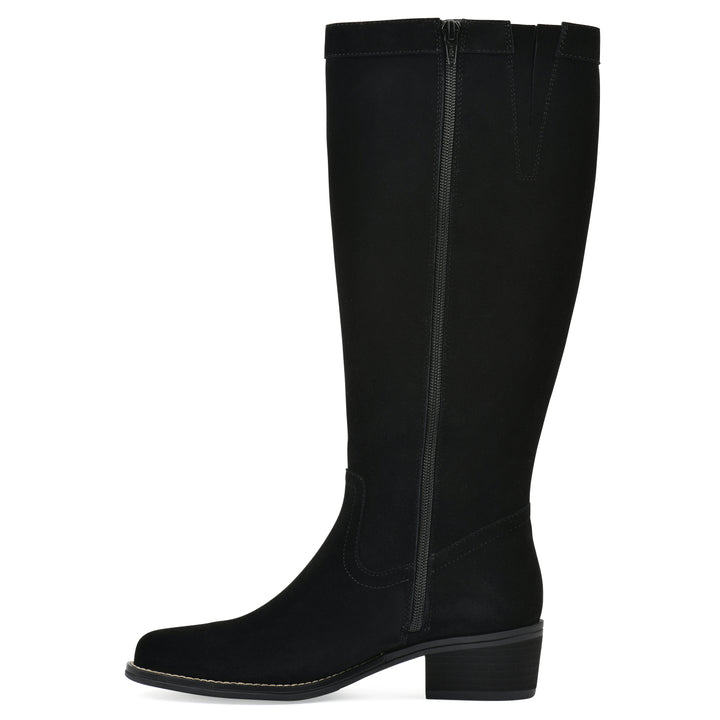 Side view of a black suede tall boot with a low stacked, black heel, and tapered toe