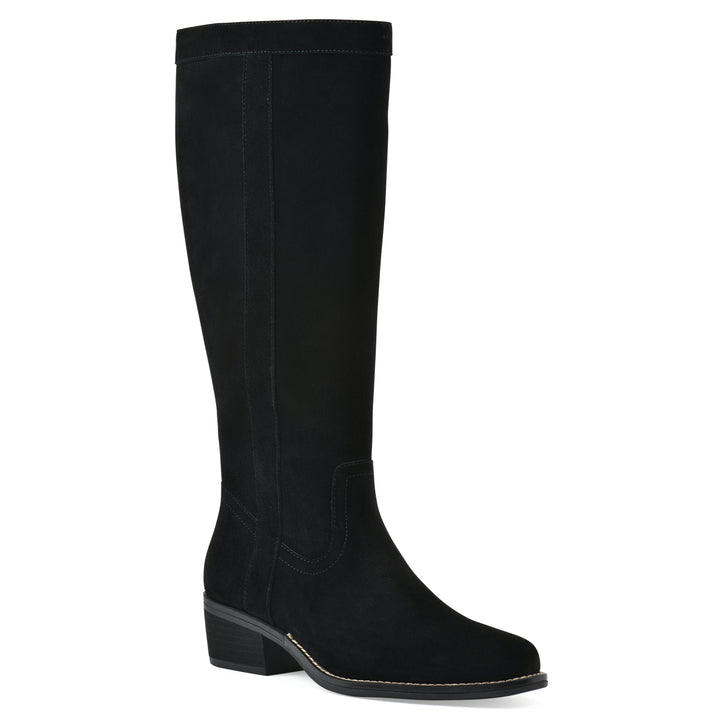 Angle view of a black suede tall boot with a low stacked, black heel, and tapered toe