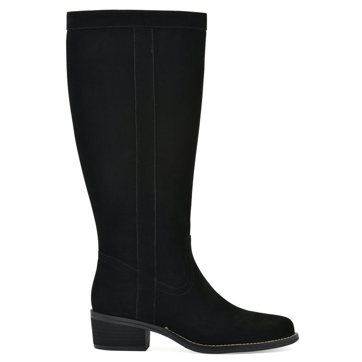 Side view of a black suede tall boot with a low stacked, black heel, and tapered toe