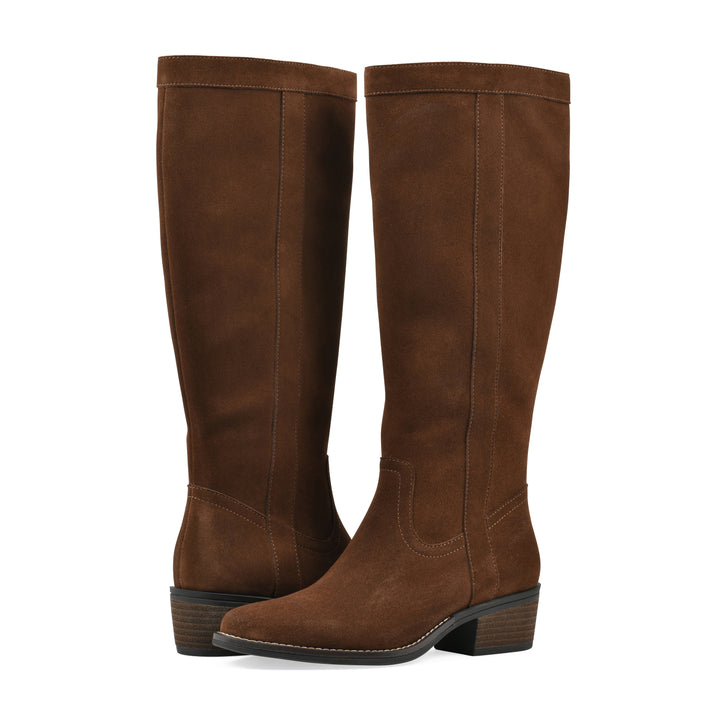 Angle view of a pair of chestnut suede tall boots with a low stacked, dark brown heel, and tapered toe