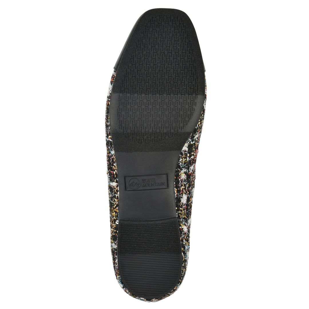 Sole view of a black boucle fabric flat with small, centered black bow, a smooth black patent toe cap, and a black sole