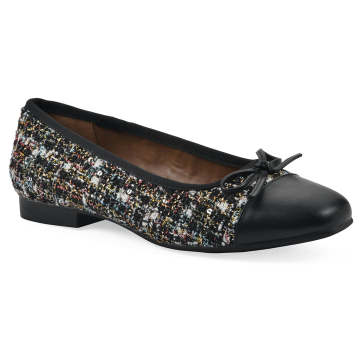 Angle view of a black boucle fabric flat with small, centered black bow, a smooth black patent toe cap, and a black sole