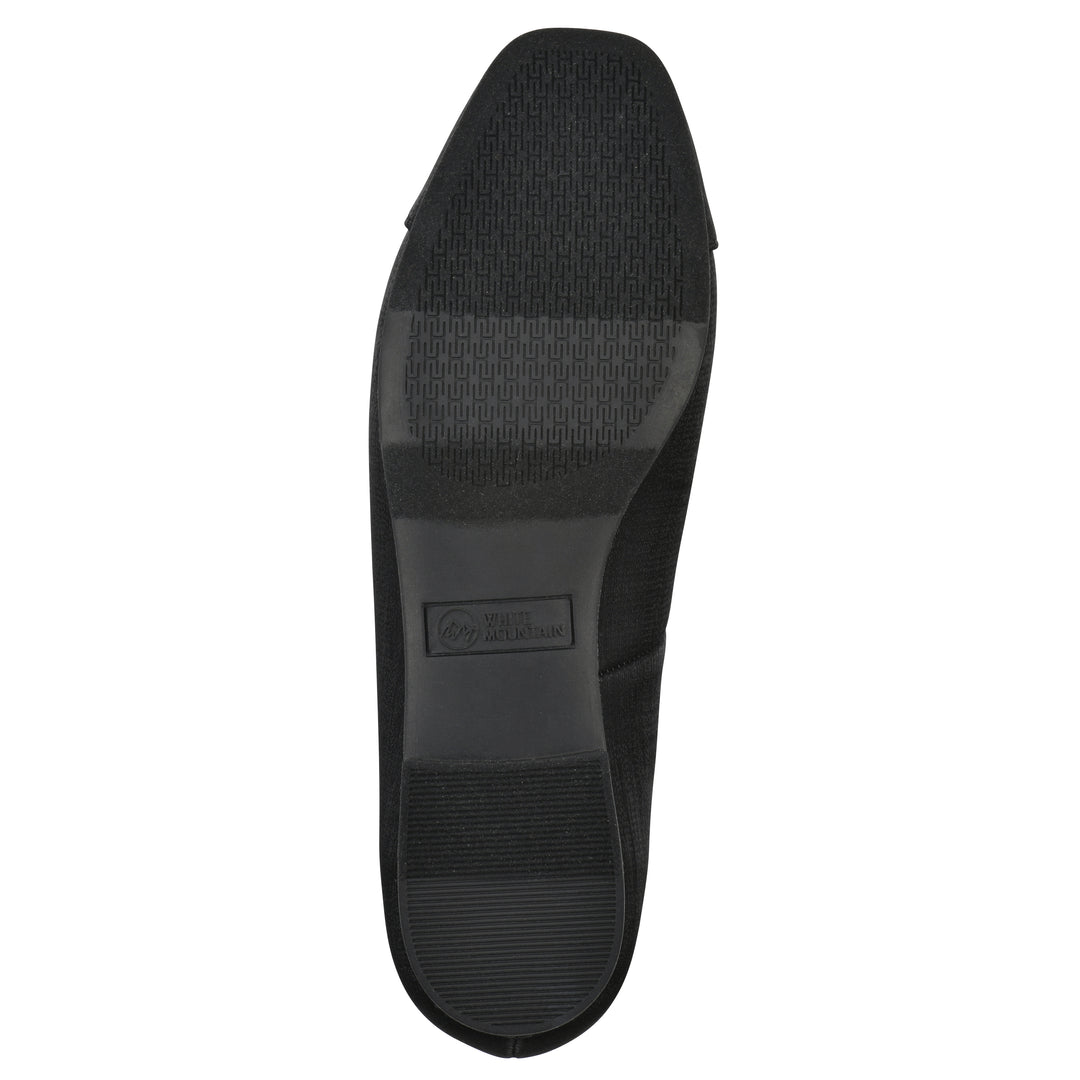 Sole view of a black shimmer fabric flat with small, centered black bow and a black sole