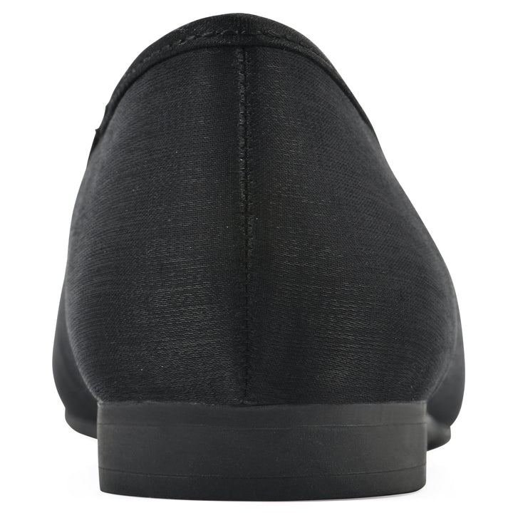Rear view of a black shimmer fabric flat with small, centered black bow and a black sole