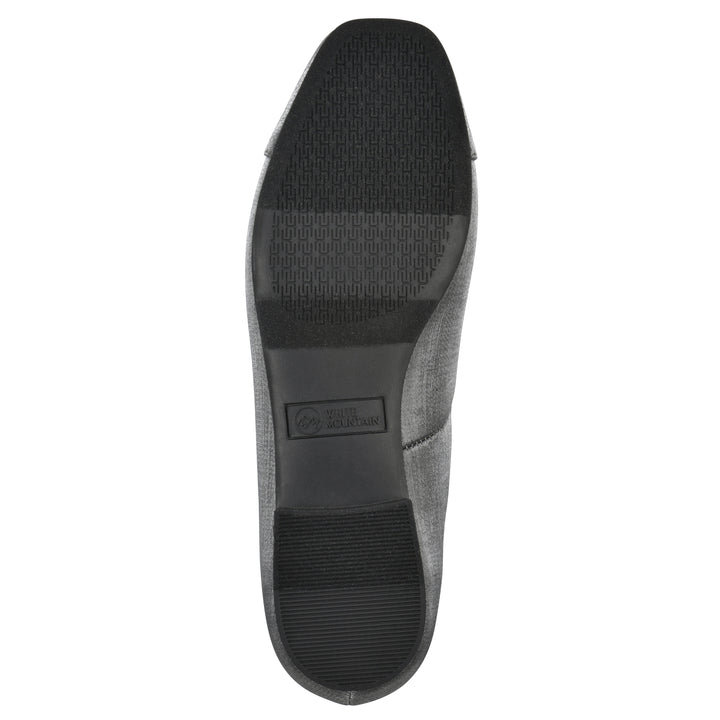Sole view of a gunmetal shimmer fabric flat with small, centered black bow and a black sole
