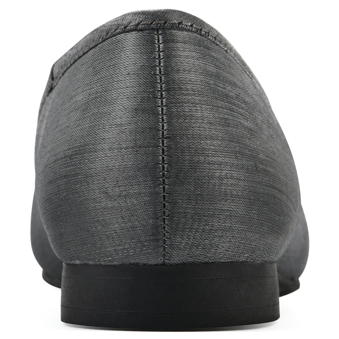 Rear view of a gunmetal shimmer fabric flat with small, centered black bow and a black sole