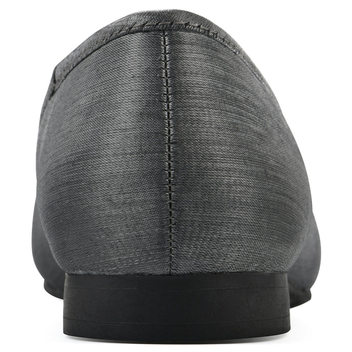 Rear view of a gunmetal shimmer fabric flat with small, centered black bow and a black sole