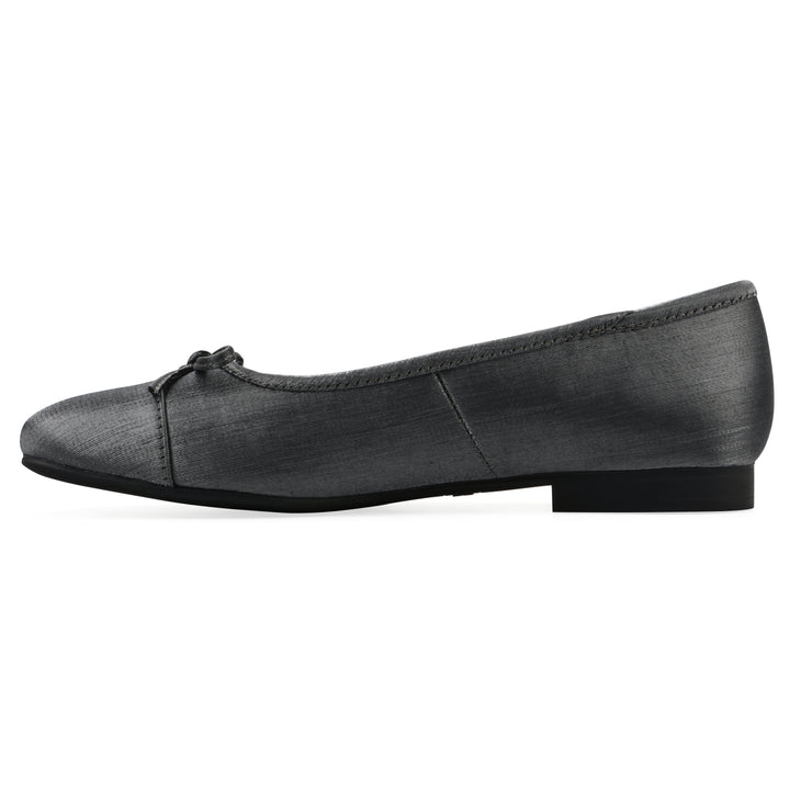 Side view of a gunmetal shimmer fabric flat with small, centered black bow and a black sole