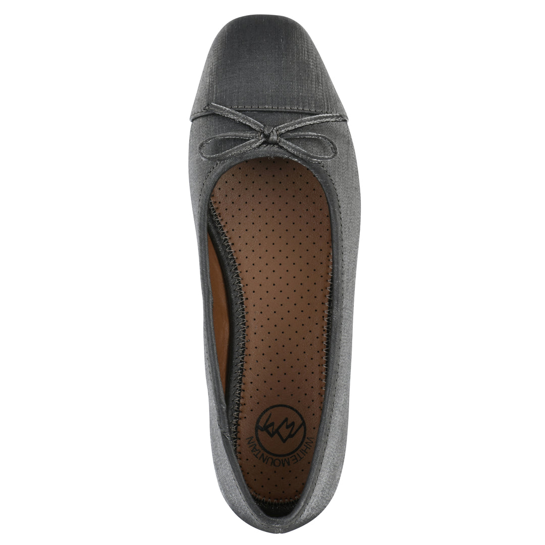Top view of a gunmetal shimmer fabric flat with small, centered black bow and a black sole
