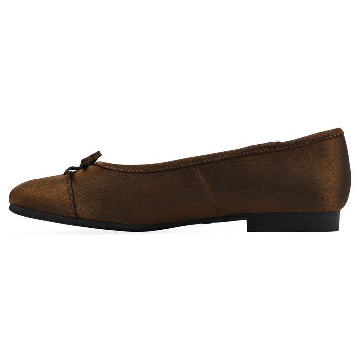 Side view of a bronze shimmer fabric flat with small, centered black bow and a black sole