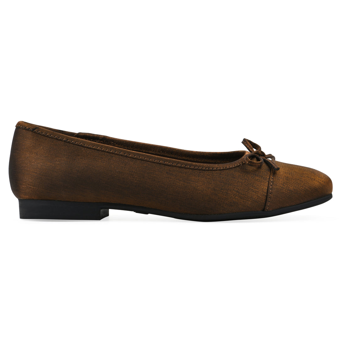 Side view of a bronze shimmer fabric flat with small, centered black bow and a black sole