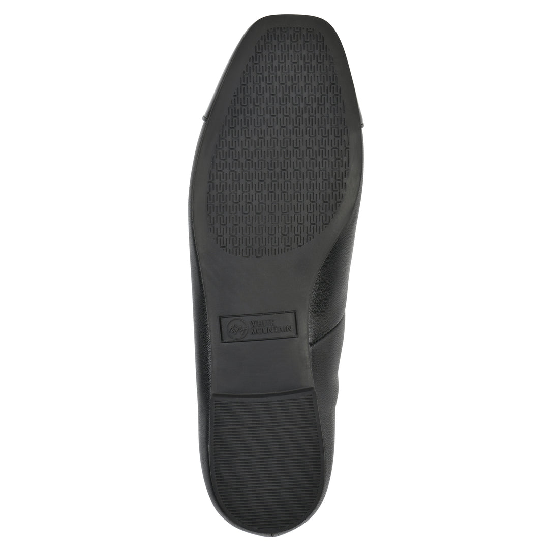 Sole view of a black faux leather flat with small, centered black bow, a smooth black patent toe cap, and a black sole