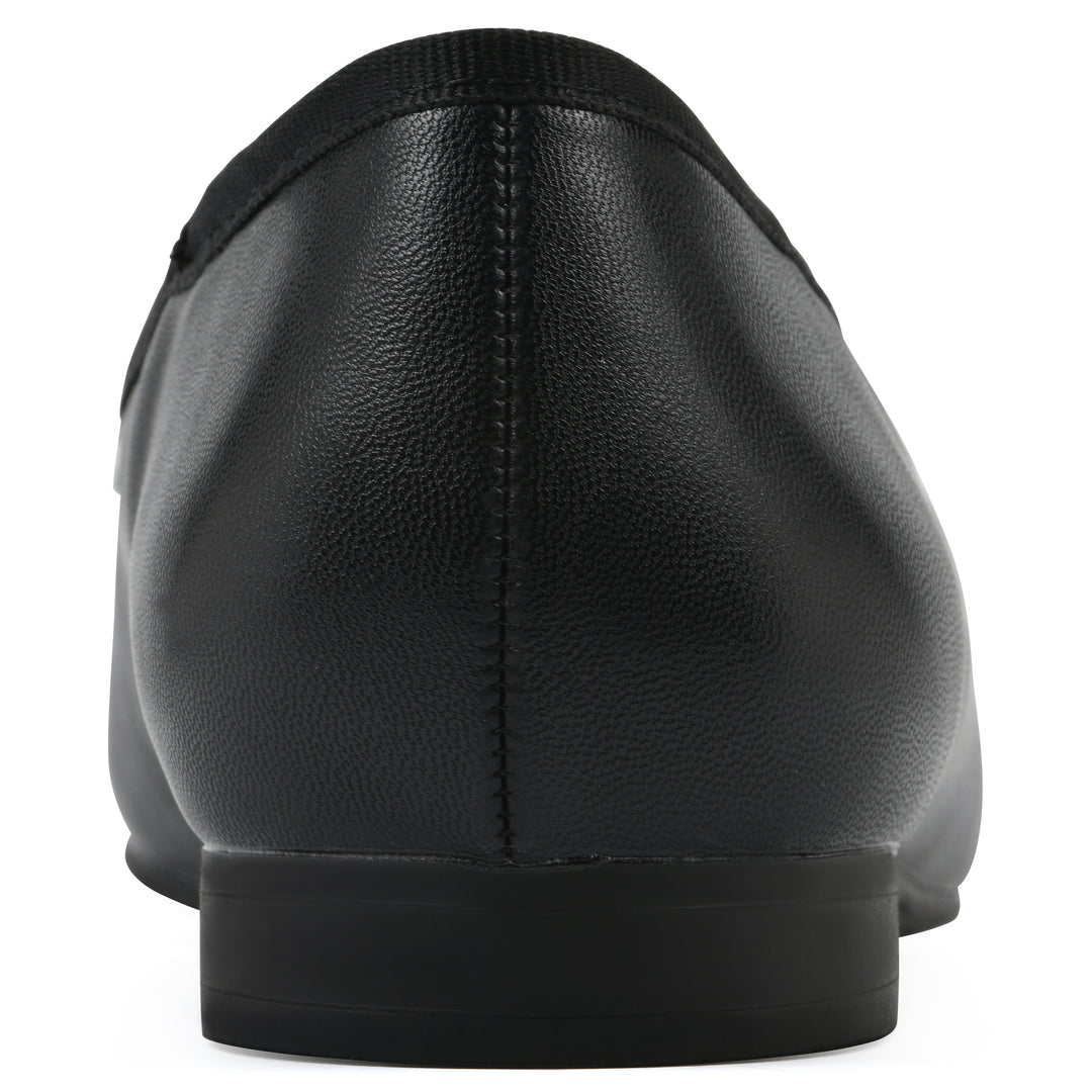 Rear view of a black faux leather flat with small, centered black bow, a smooth black patent toe cap, and a black sole