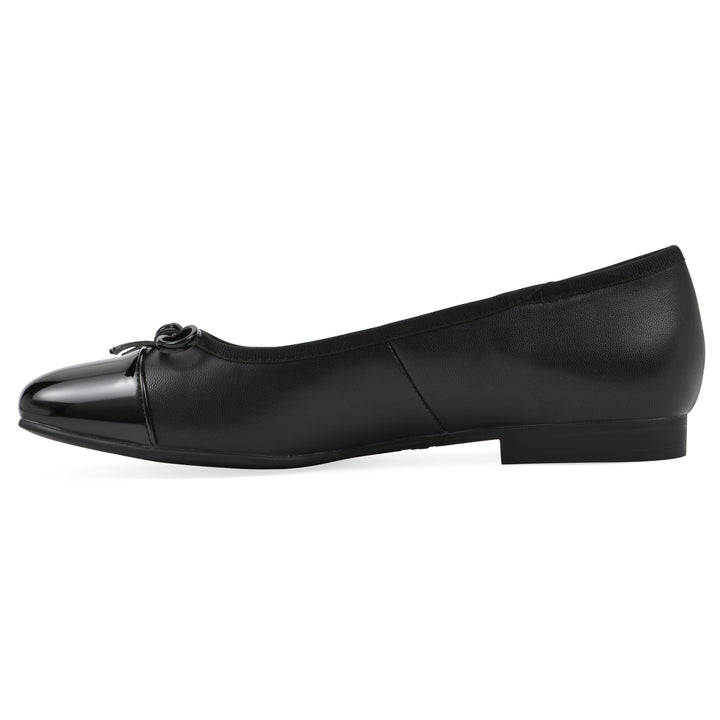 Side view of a black faux leather flat with small, centered black bow, a smooth black patent toe cap, and a black sole