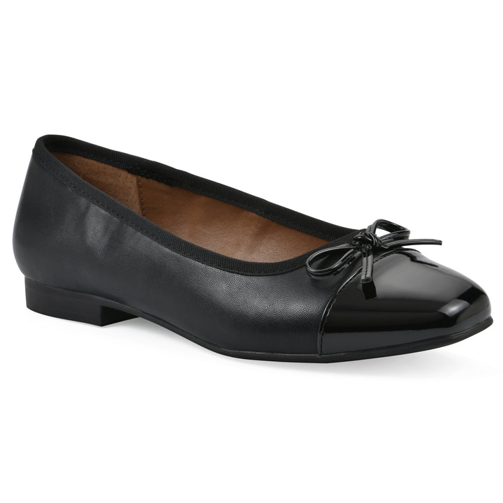 Angle view of a black faux leather flat with small, centered black bow, a smooth black patent toe cap, and a black sole