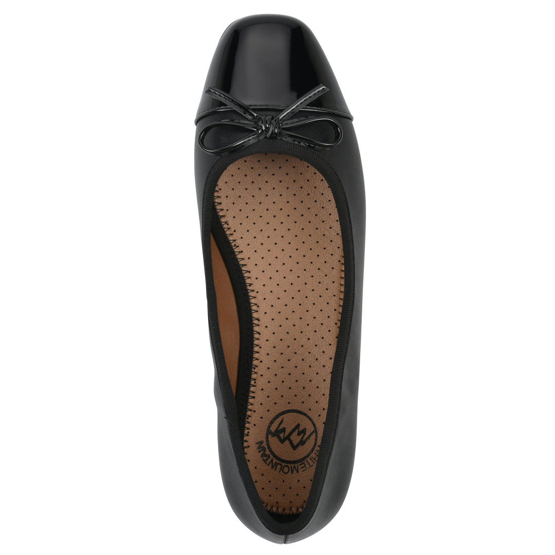 Top view of a black faux leather flat with small, centered black bow, a smooth black patent toe cap, and a black sole