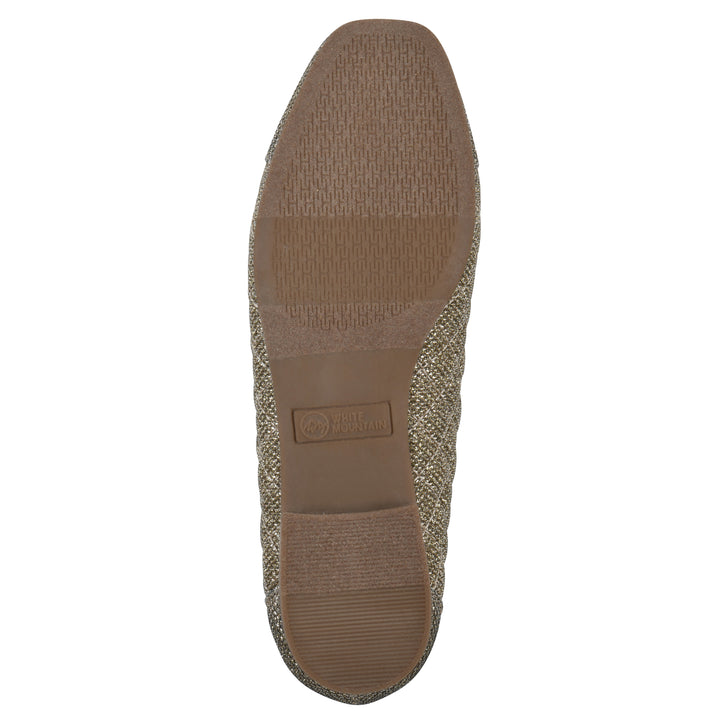 Sole view of a gold glitter quilted pattern flat with small, centered bow and a brown sole