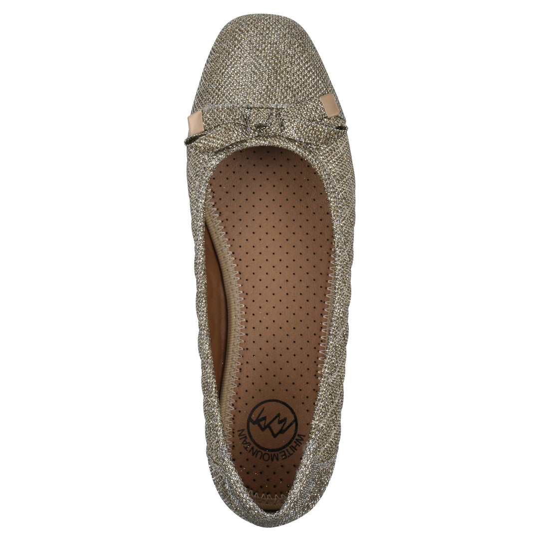 Top view of a gold glitter quilted pattern flat with small, centered bow and a brown sole