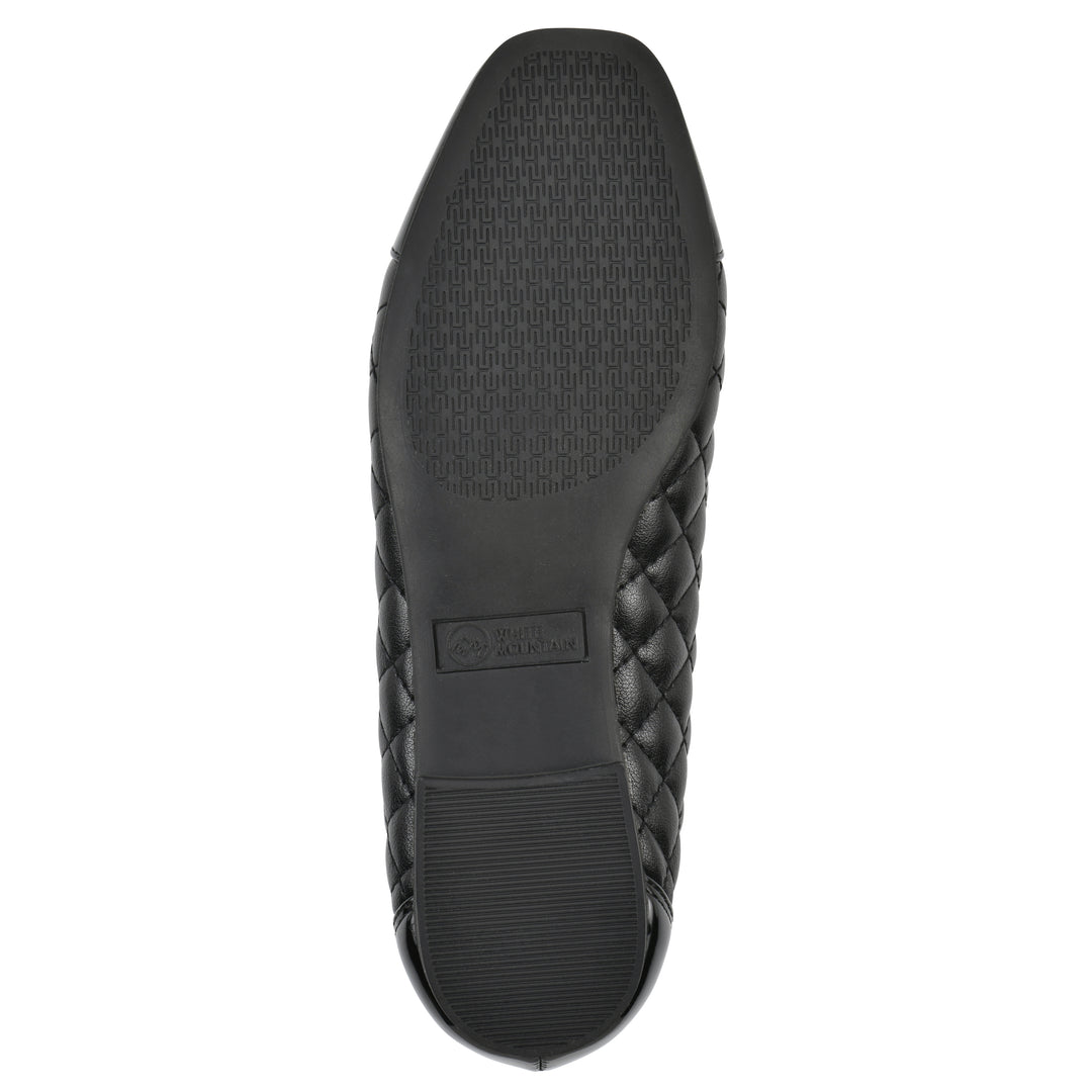 Sole view of a black quilted pattern flat with smooth patent toe cap, small, centered bow and a black sole