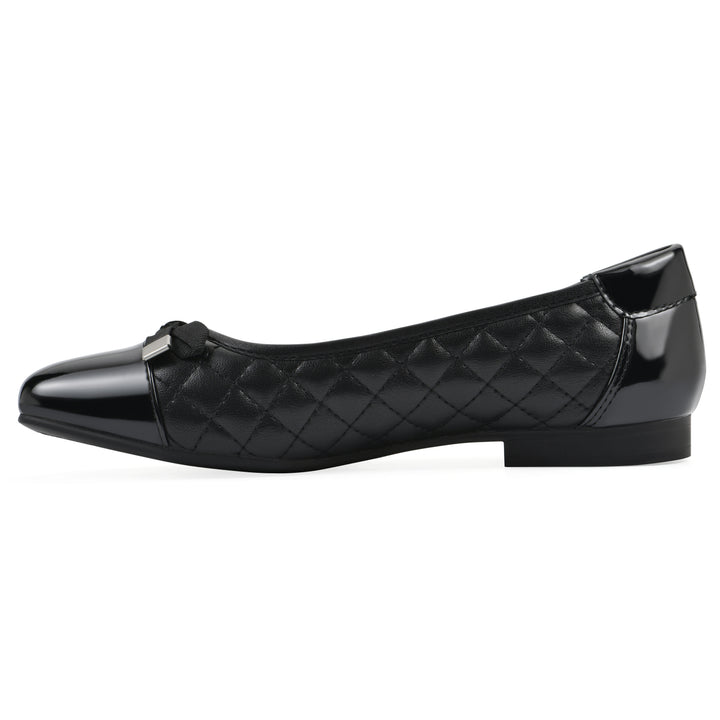 Side view of a black quilted pattern flat with smooth patent toe cap, small, centered bow and a black sole