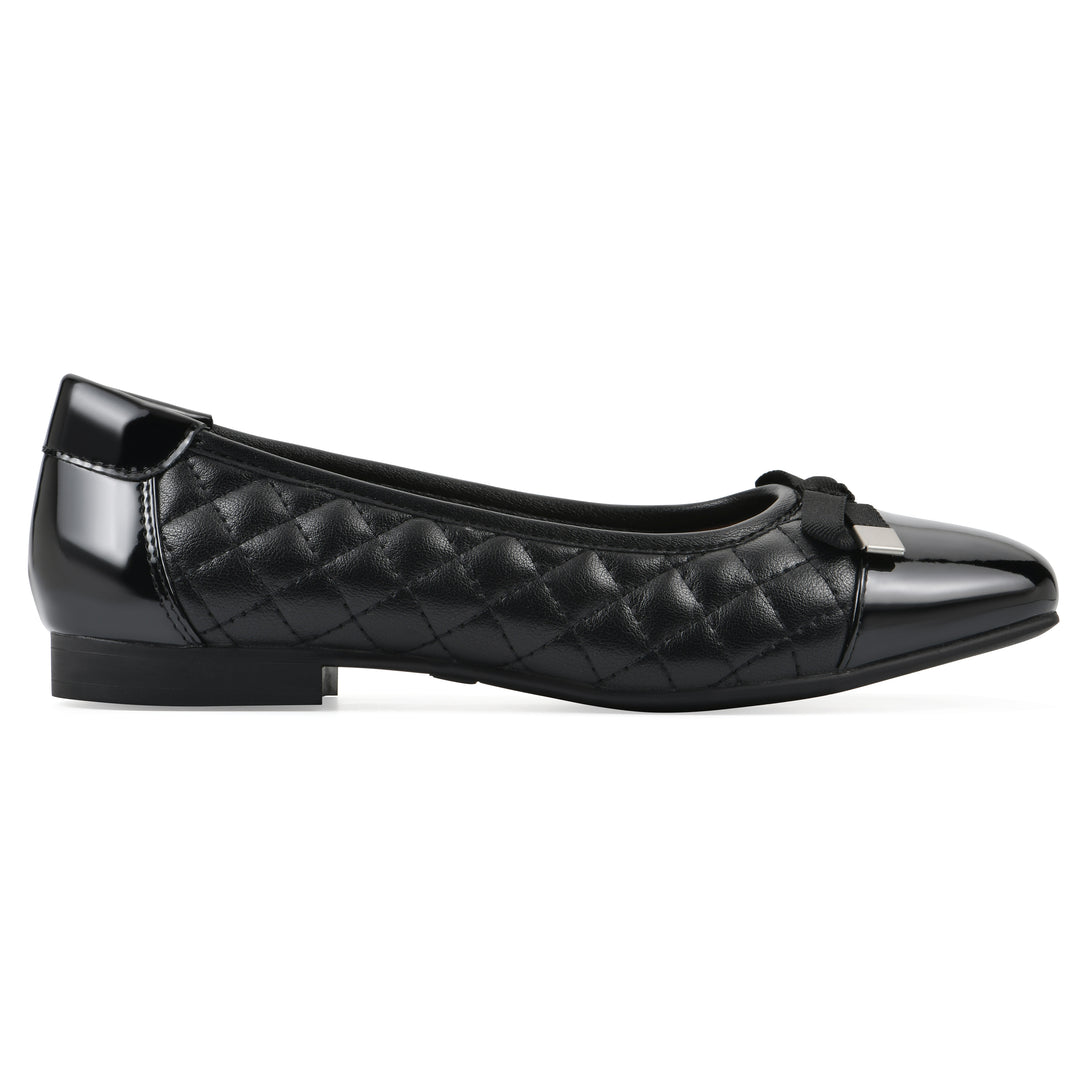 Side view of a black quilted pattern flat with smooth patent toe cap, small, centered bow and a black sole