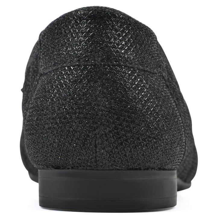 Rear view of a black glitter quilted pattern flat with small, centered bow and a black sole